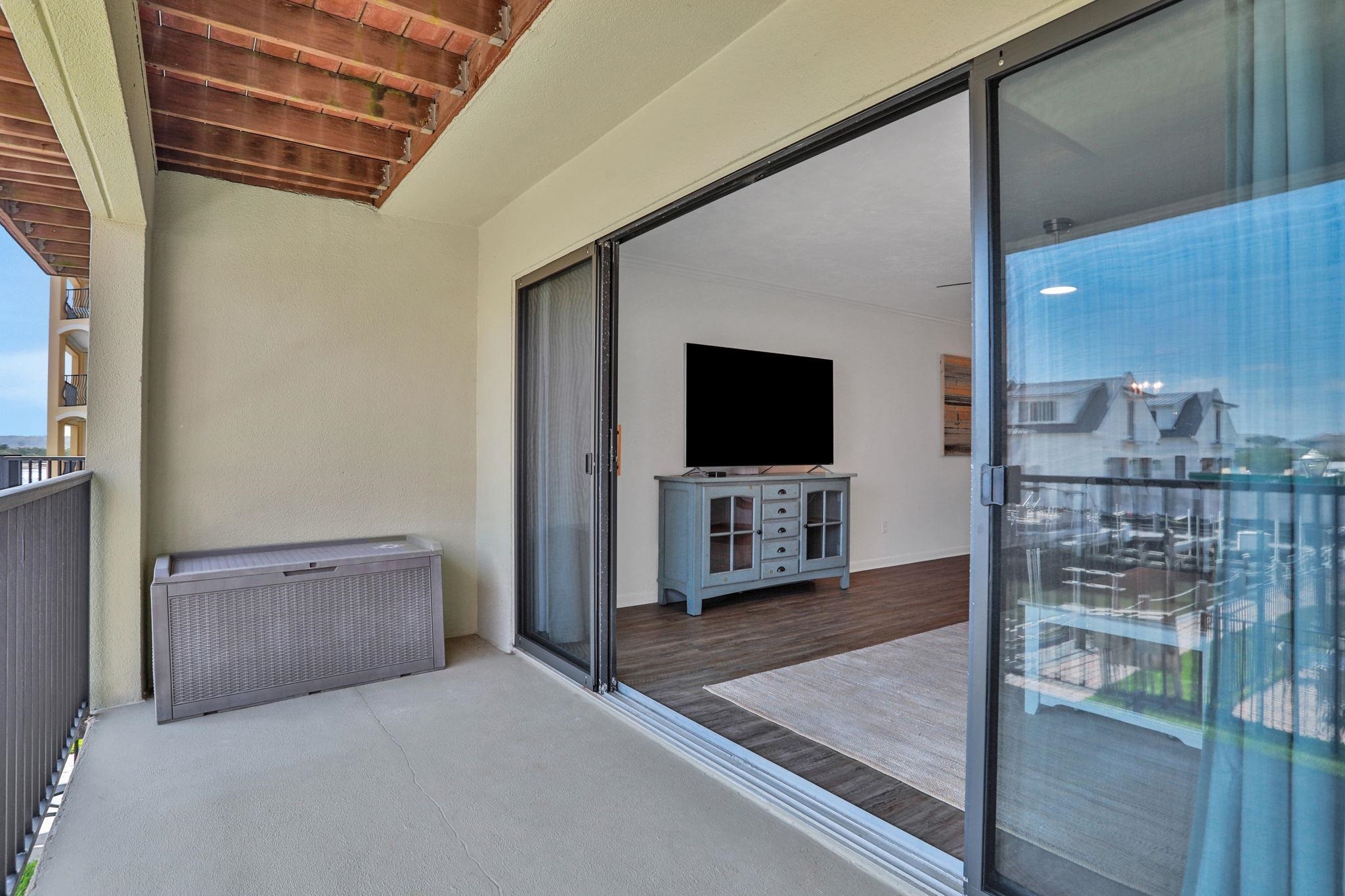 120 Sunset Harbor Way, Unit 202 St. Augustine, FL 32080 - Photo 16 of 50 a living room with furniture and a flat screen tv