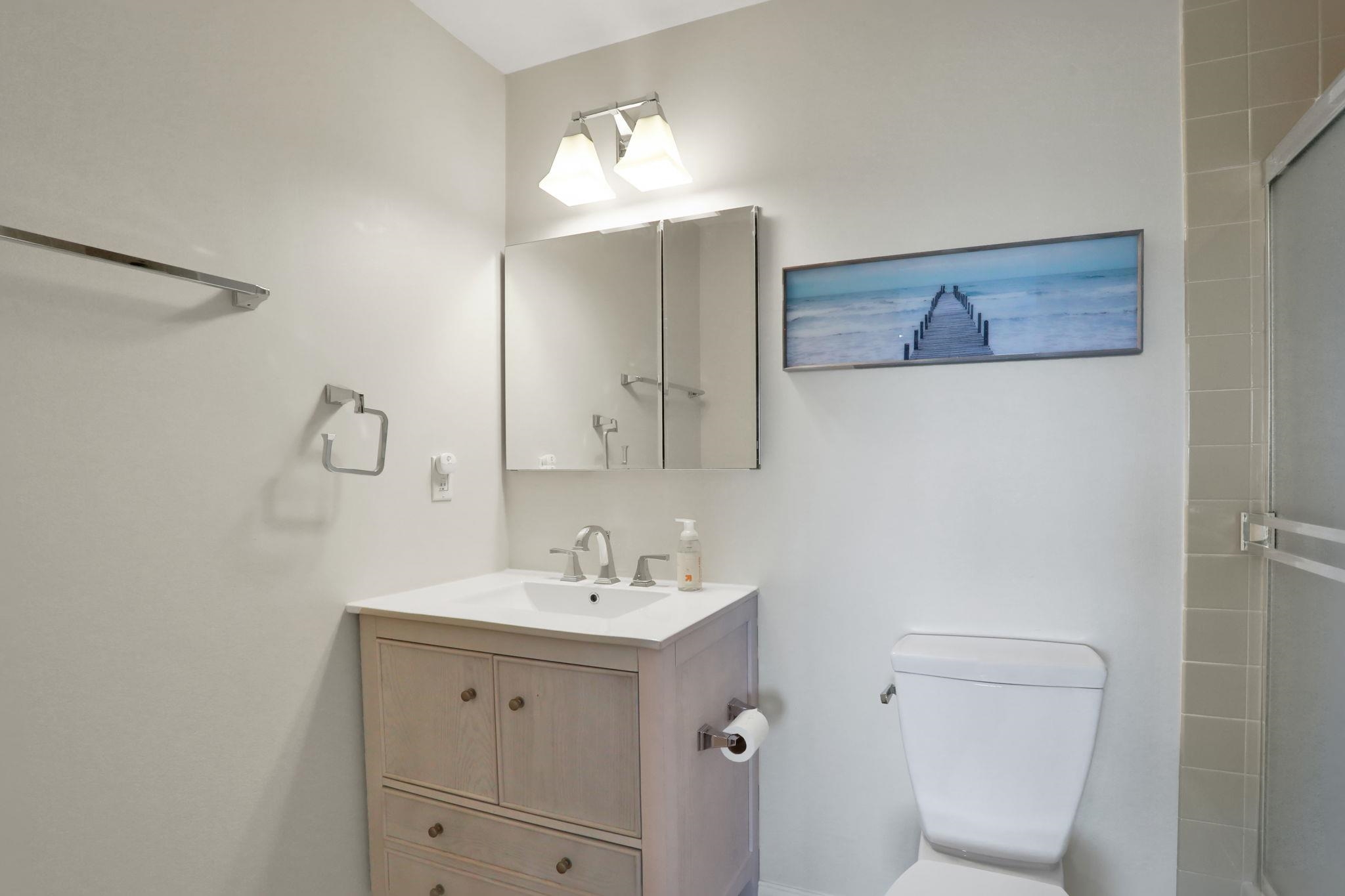 120 Sunset Harbor Way, Unit 202 St. Augustine, FL 32080 - Photo 24 of 50 a bathroom with a toilet sink and mirror