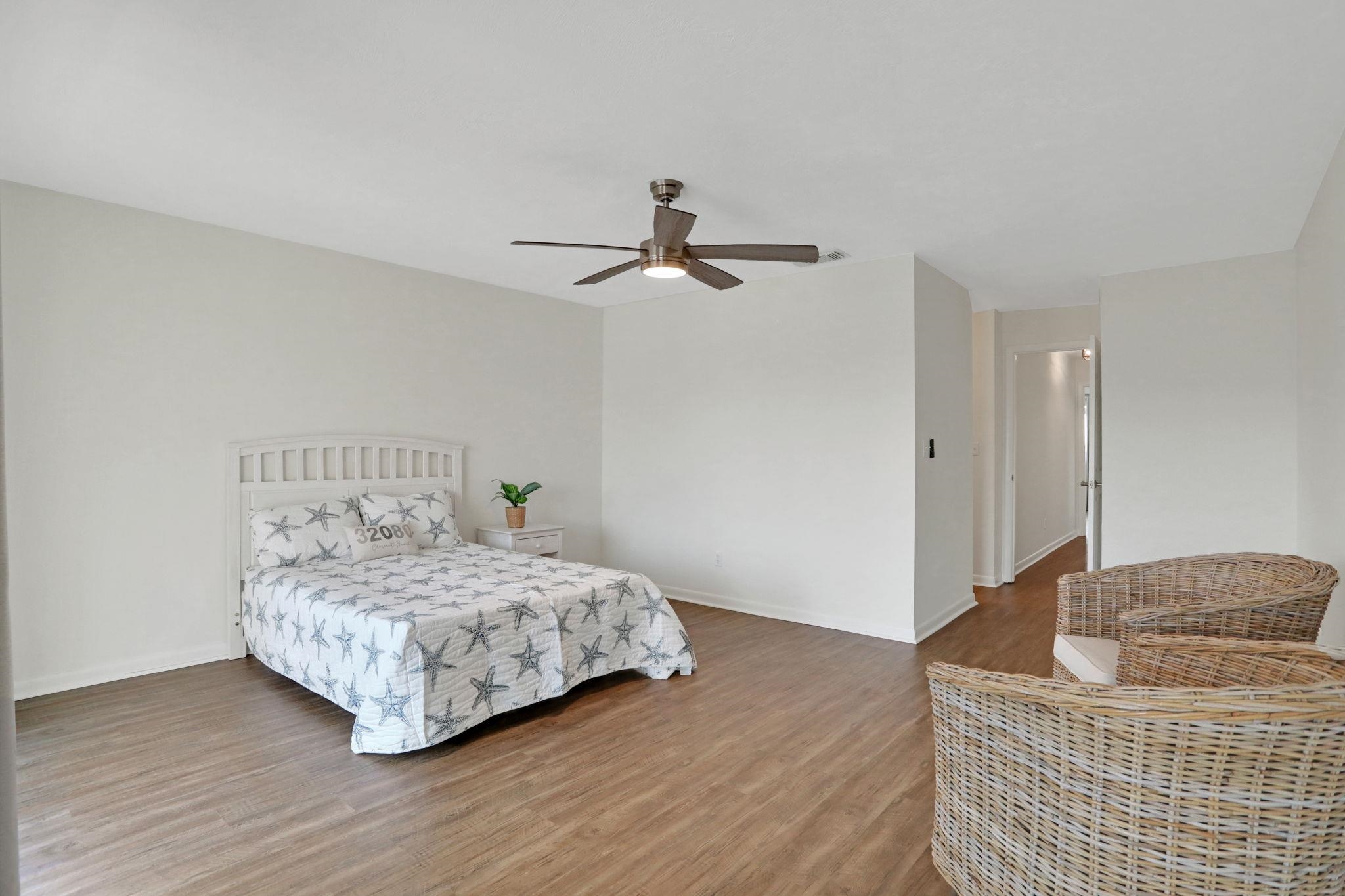 120 Sunset Harbor Way, Unit 202 St. Augustine, FL 32080 - Photo 25 of 50 a bedroom with a bed and wooden floor