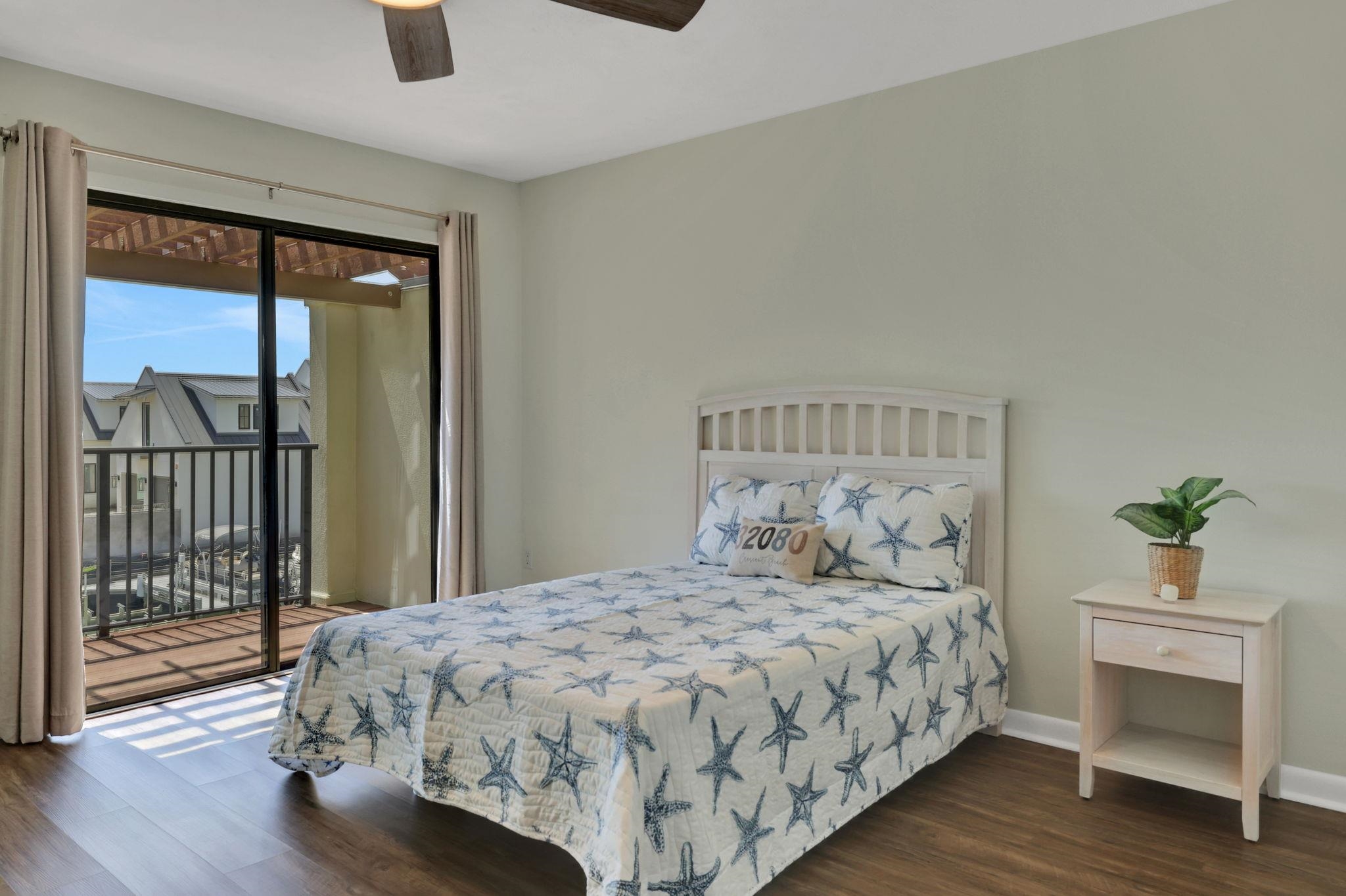 120 Sunset Harbor Way, Unit 202 St. Augustine, FL 32080 - Photo 27 of 50 a bedroom with a bed and wooden floor