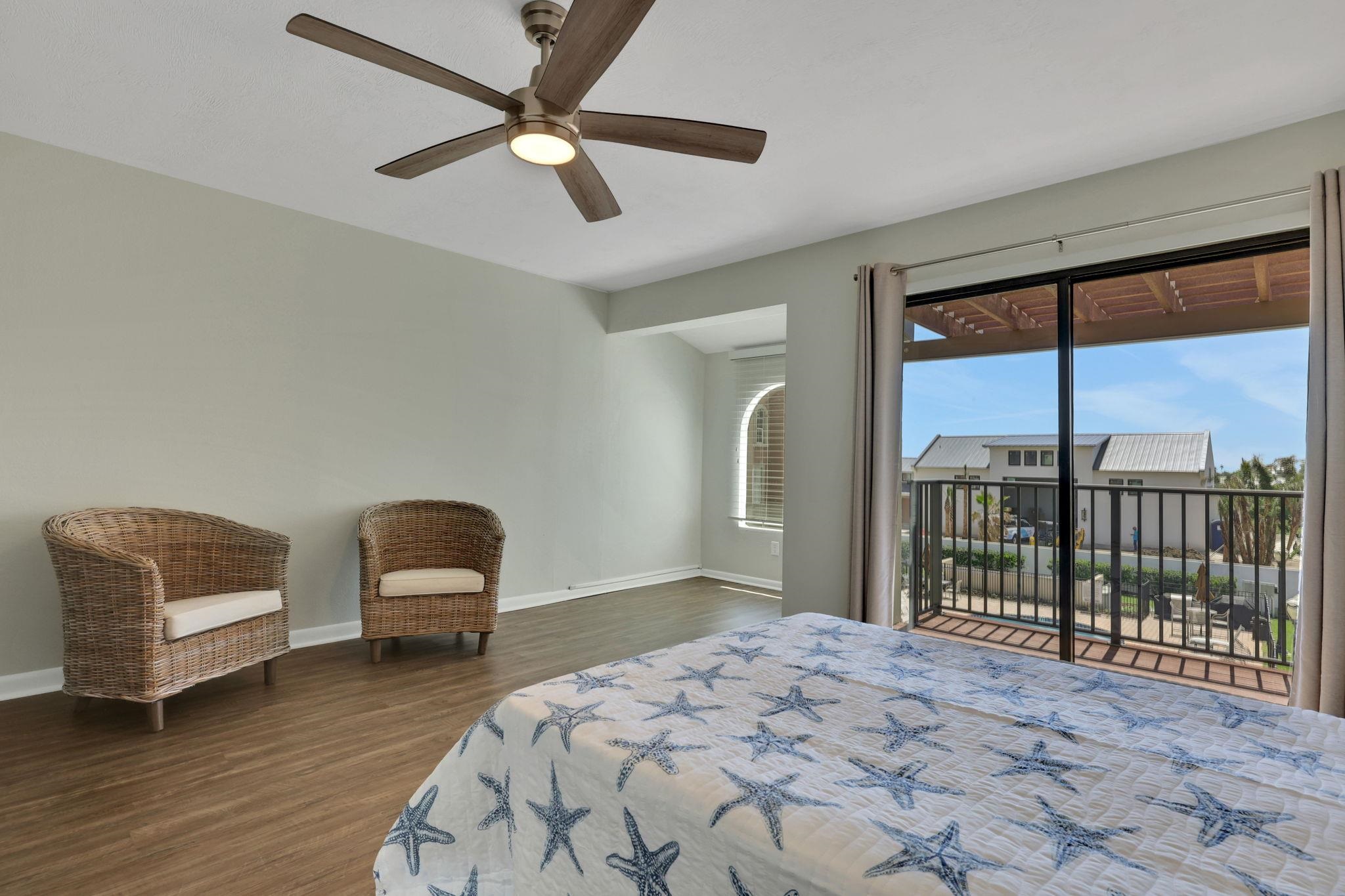 120 Sunset Harbor Way, Unit 202 St. Augustine, FL 32080 - Photo 29 of 50 a bedroom with a bed a couch and a large window