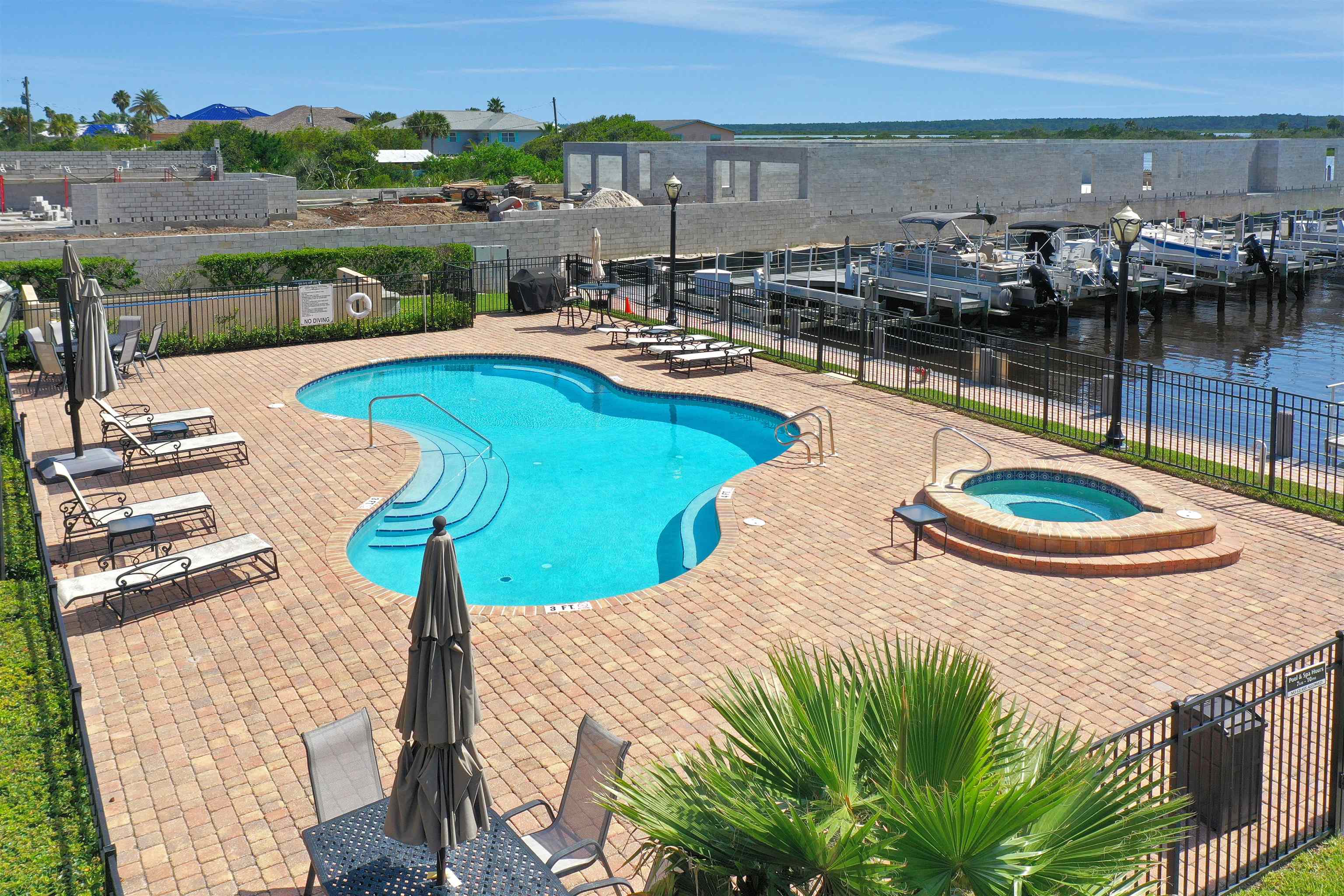 120 Sunset Harbor Way, Unit 202 St. Augustine, FL 32080 - Photo 39 of 50 a view of a swimming pool with a table and chairs