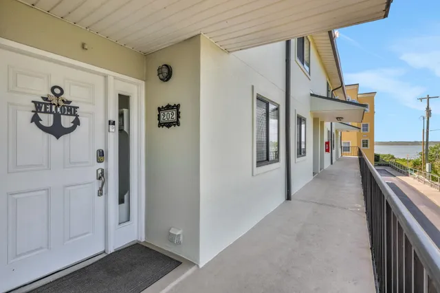 a view of a hallway with wooden floor and closet