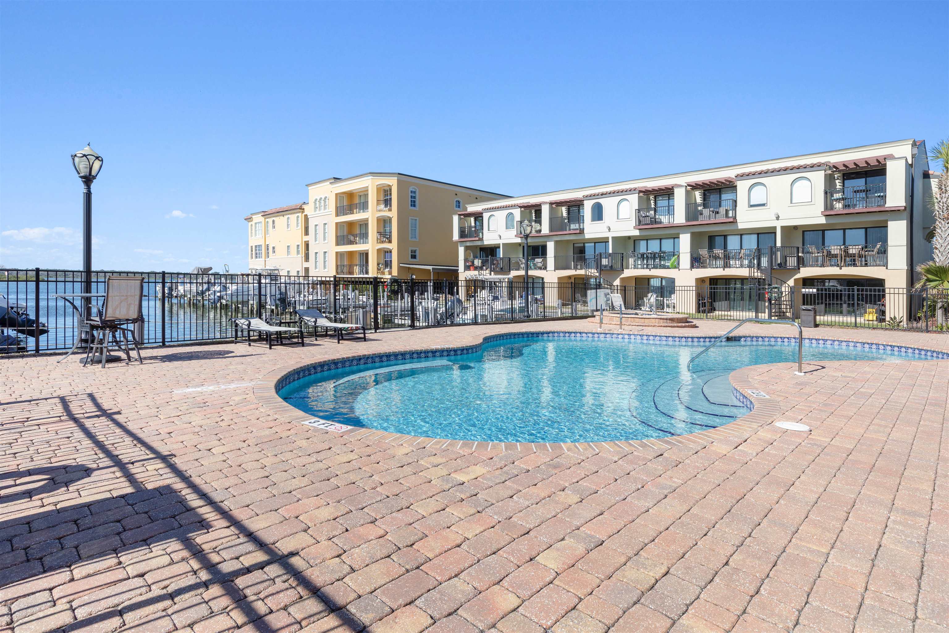 120 Sunset Harbor Way, Unit 202 St. Augustine, FL 32080 - Photo 41 of 50 a view of a swimming pool with a lounge chair