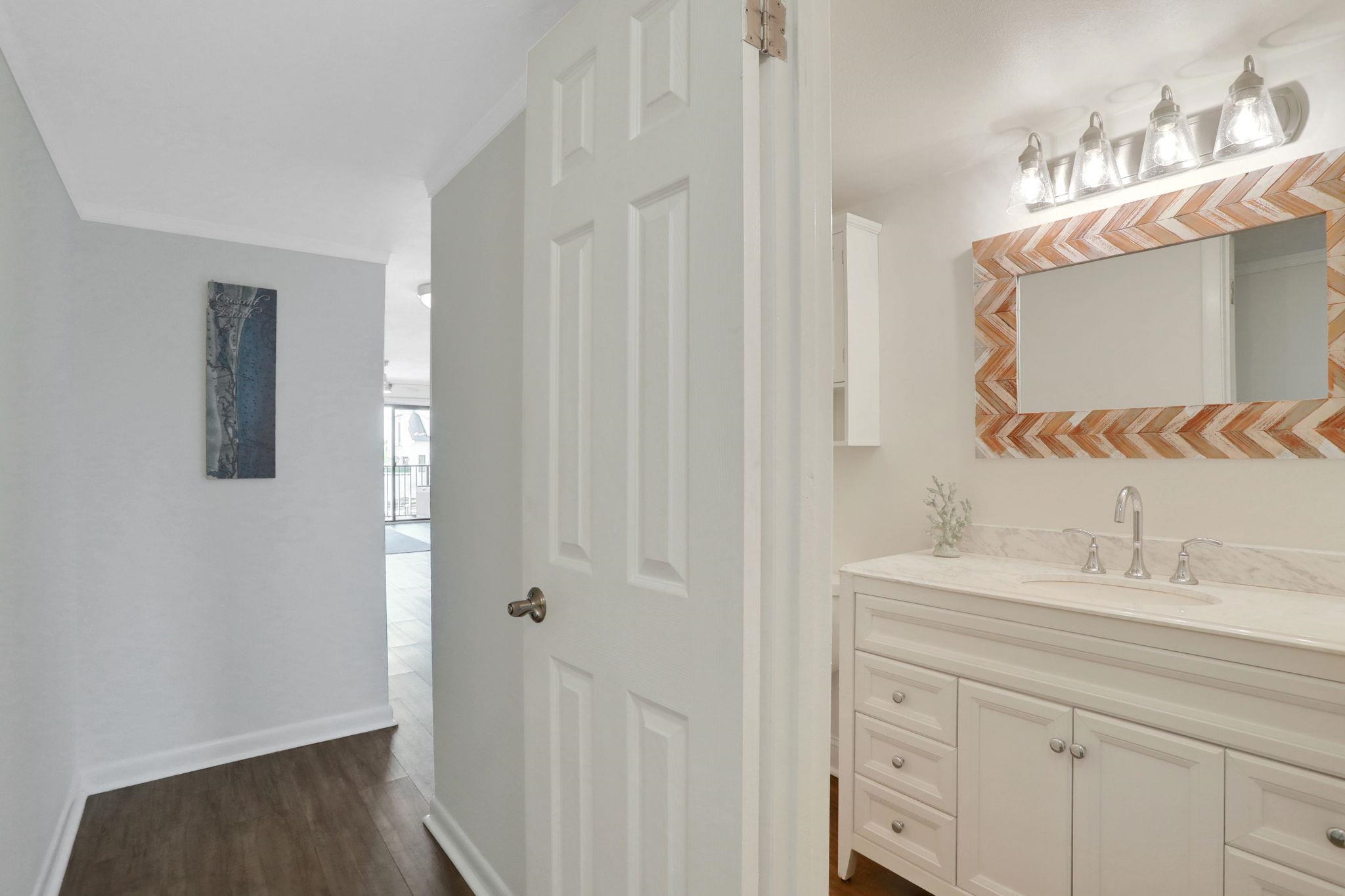 120 Sunset Harbor Way, Unit 202 St. Augustine, FL 32080 - Photo 6 of 50 a bathroom with a sink and a mirror