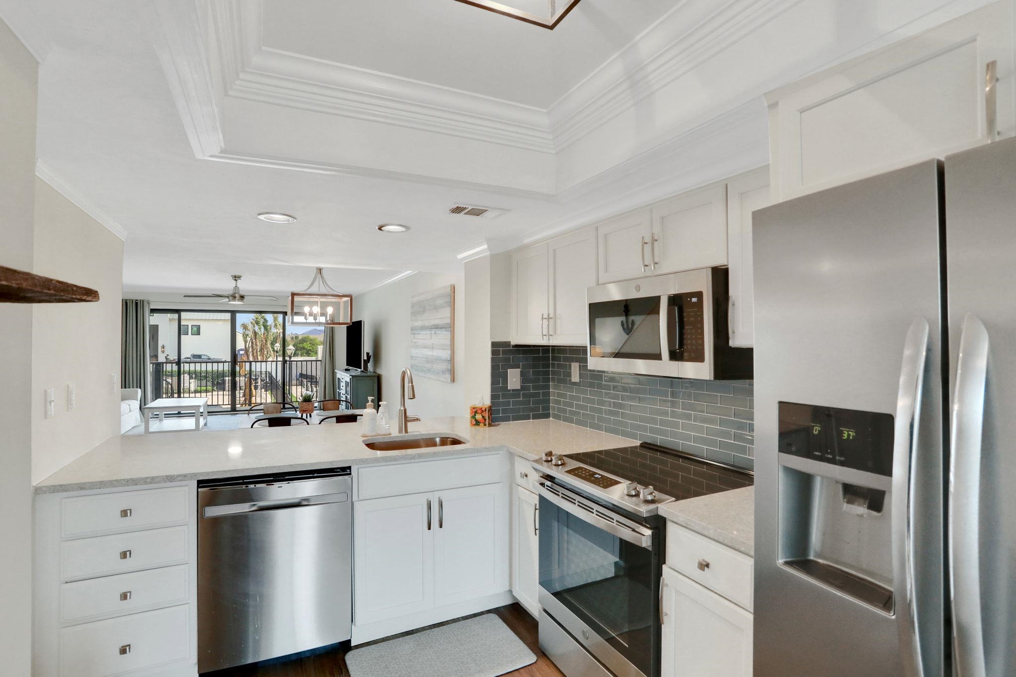 120 Sunset Harbor Way, Unit 202 St. Augustine, FL 32080 - Photo 9 of 50 a kitchen with a sink stove and refrigerator