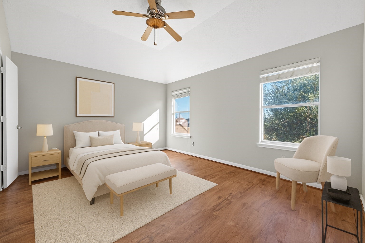 20347 Hunterclif Lane Katy, TX 77449 - Photo 1 of 39 The virtually staged primary bedroom features wood flooring, a ceiling fan, and large windows that bring in natural light.