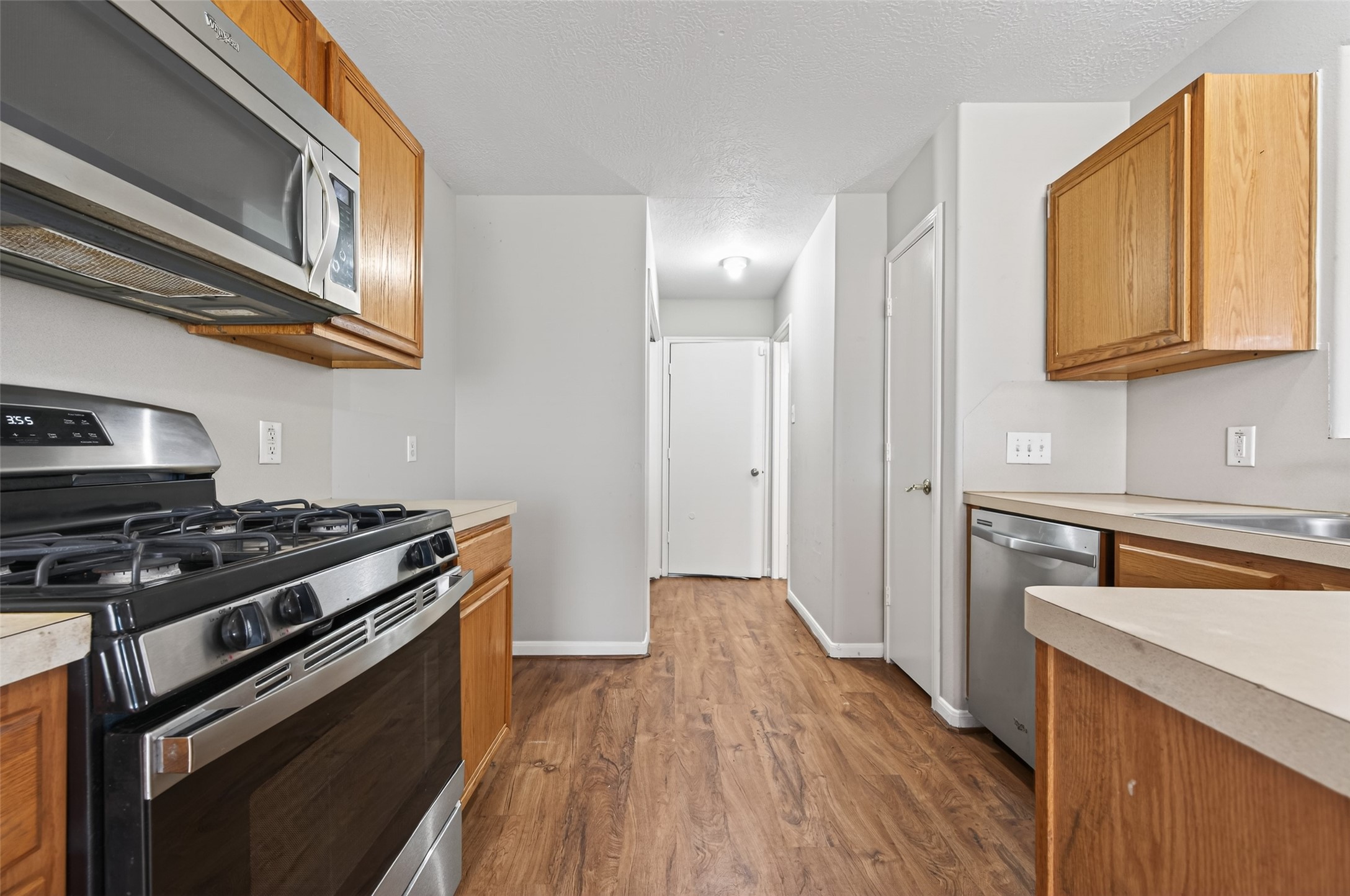 20347 Hunterclif Lane Katy, TX 77449 - Photo 14 of 39 Kitchen view showcasing the built-in microwave, gas stove, and easy access to the pantry.