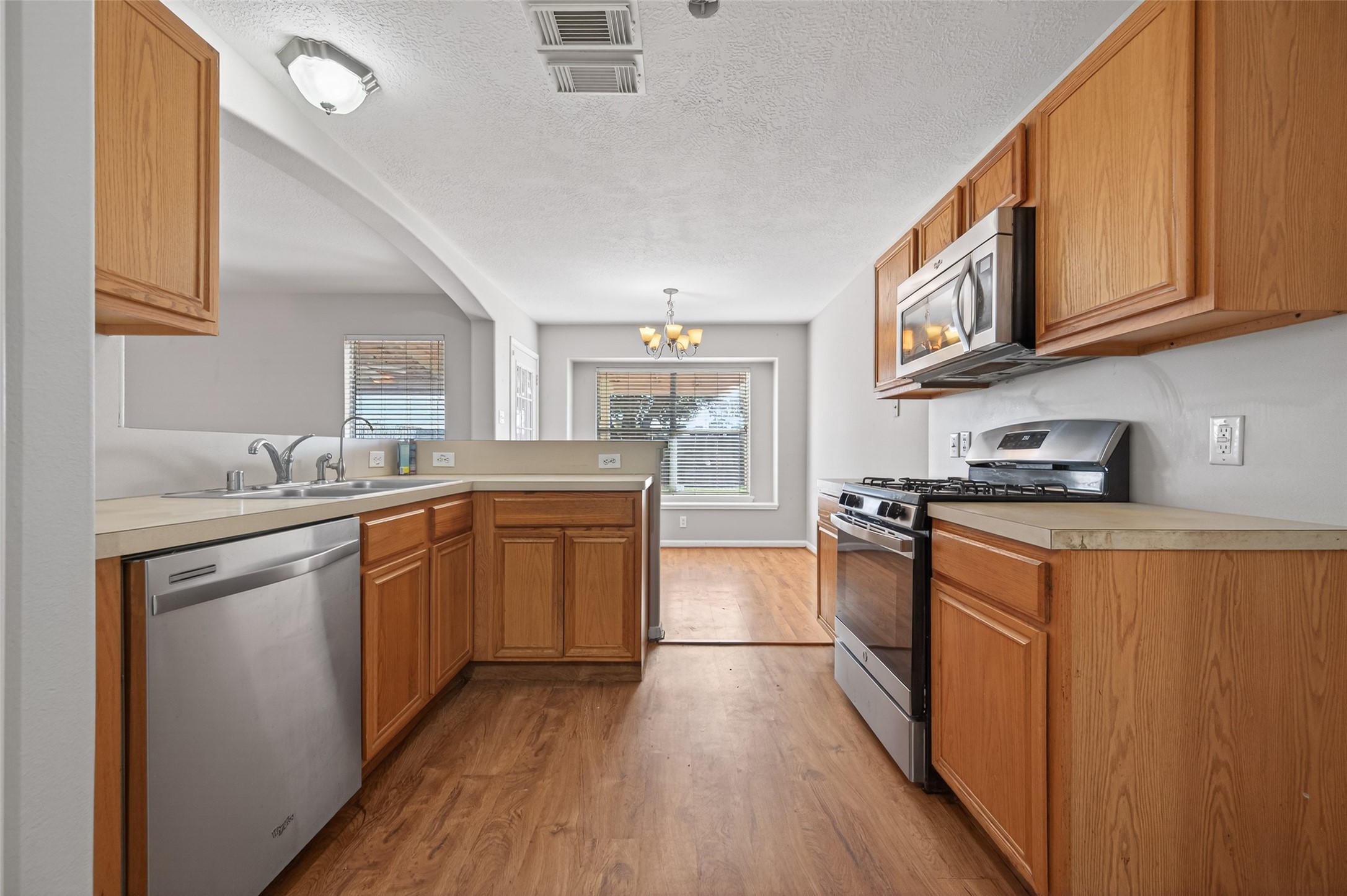 20347 Hunterclif Lane Katy, TX 77449 - Photo 17 of 39 This kitchen view features wood cabinetry, stainless steel appliances, and an open layout leading to the breakfast area.