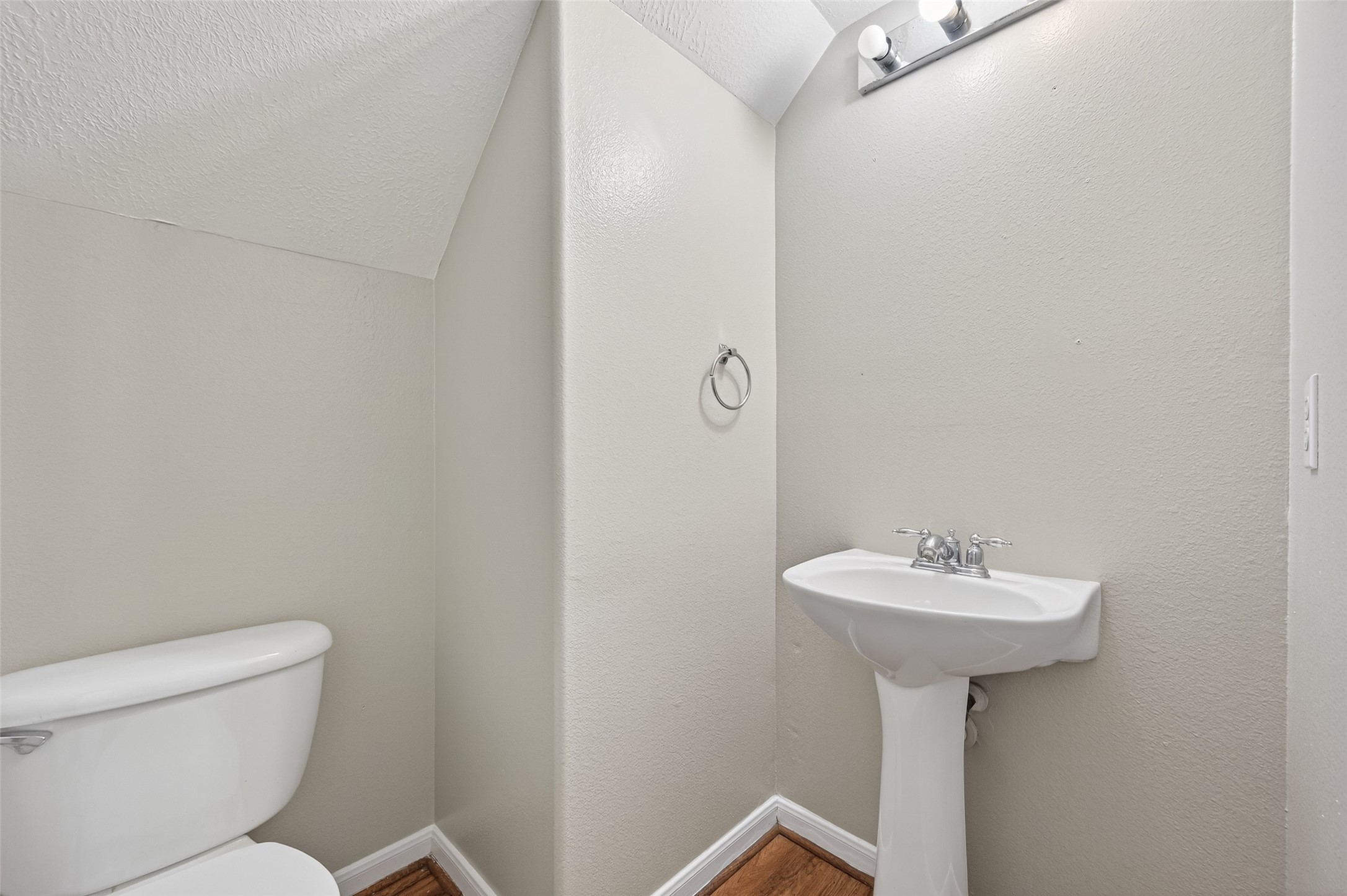 20347 Hunterclif Lane Katy, TX 77449 - Photo 19 of 39 Convenient half-bath featuring a classic white pedestal sink, vanity lighting, and neutral wall tones.