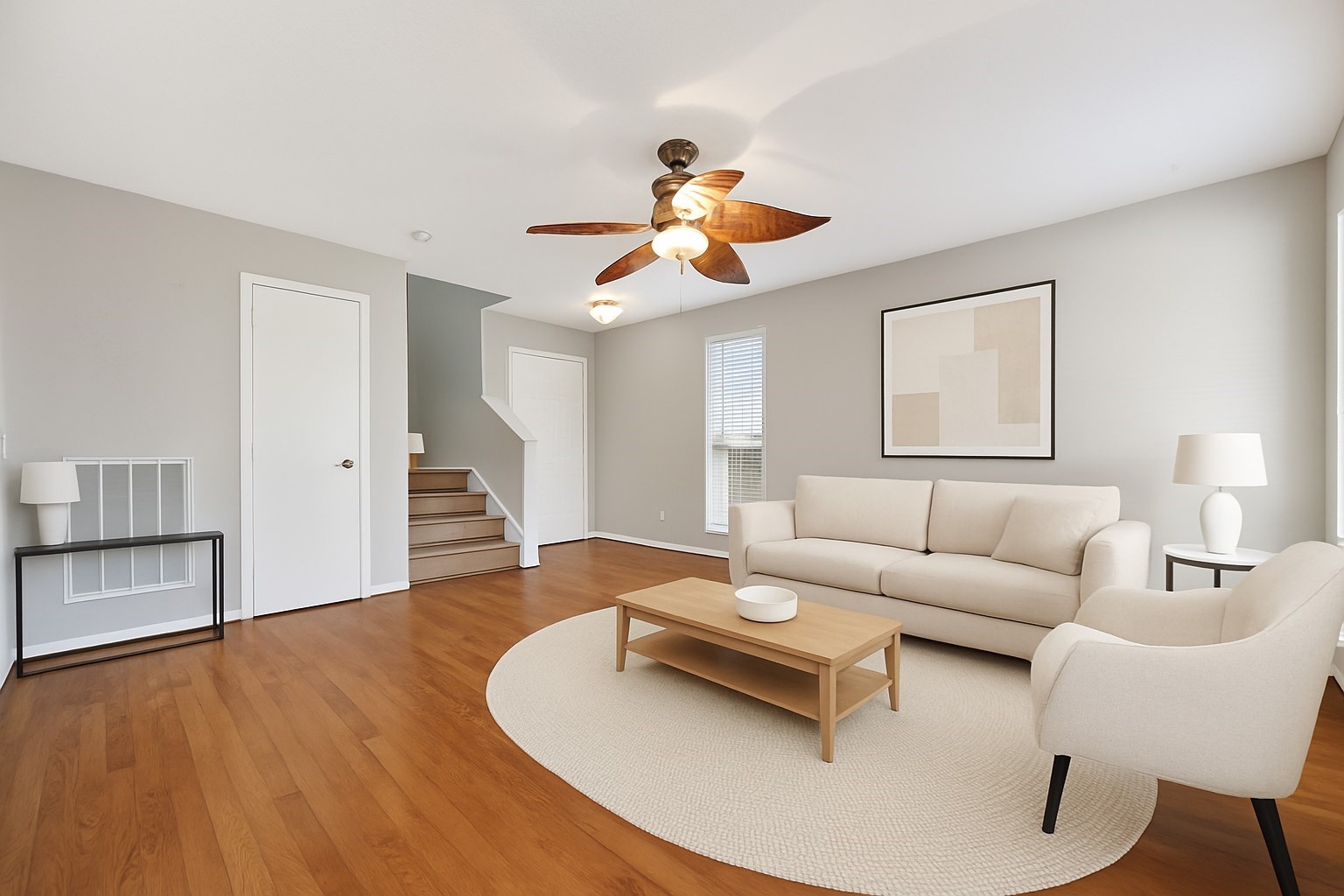 20347 Hunterclif Lane Katy, TX 77449 - Photo 2 of 39 Virtually staged living area highlighting the neutral wall colors, wood-look flooring, and ceiling fan fixture.