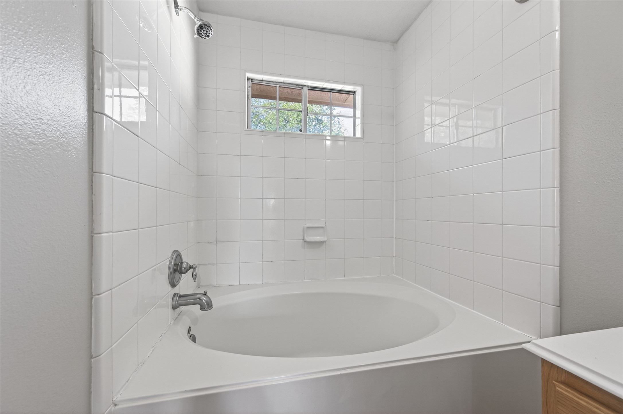 20347 Hunterclif Lane Katy, TX 77449 - Photo 26 of 39 Spa-inspired garden tub nestled in a tiled corner with a window for natural light and shower capabilities.
