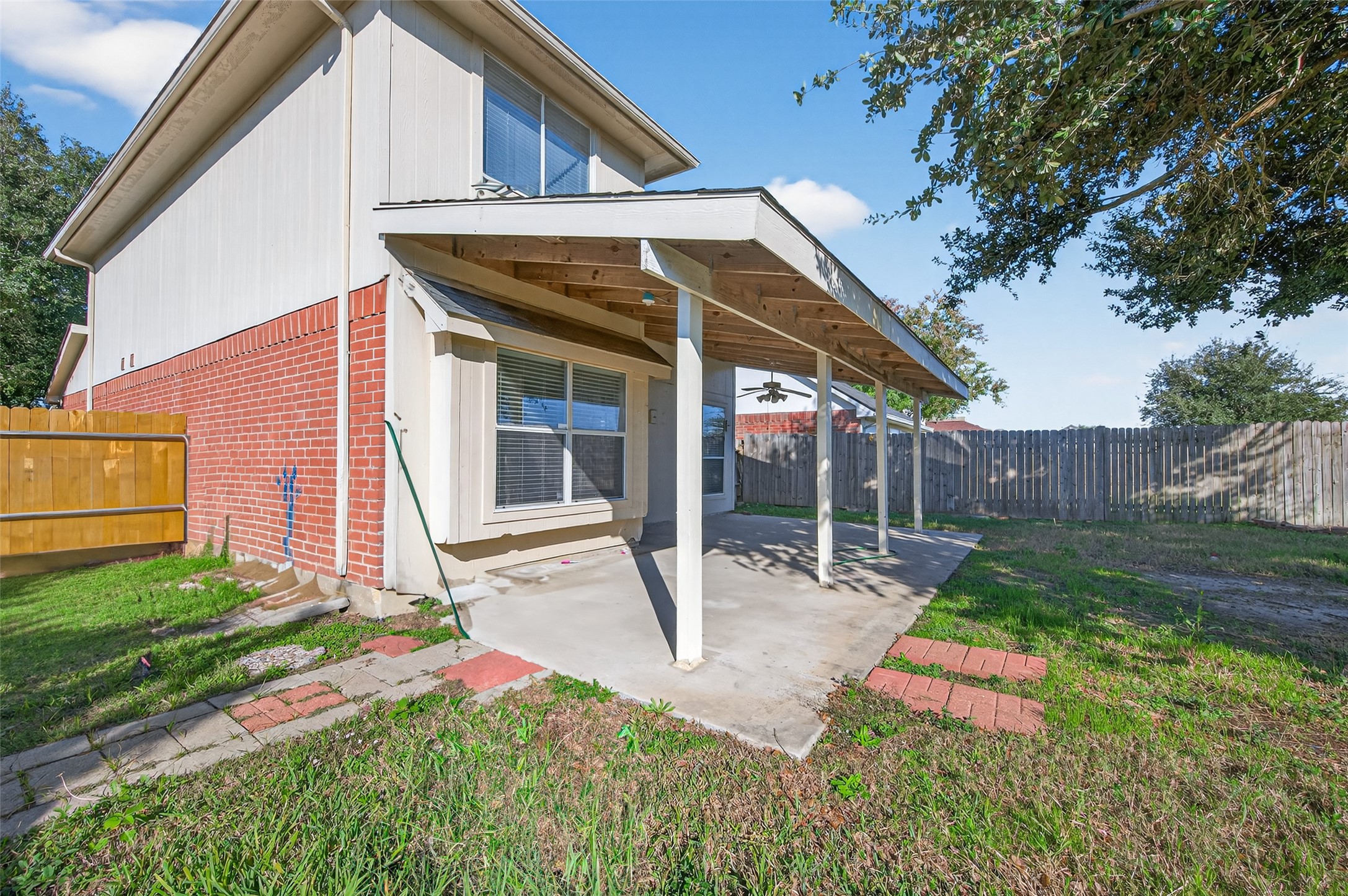 20347 Hunterclif Lane Katy, TX 77449 - Photo 36 of 39 Rear exterior profile showing the covered patio structure, durable brick and siding facade, and access to the fenced yard.