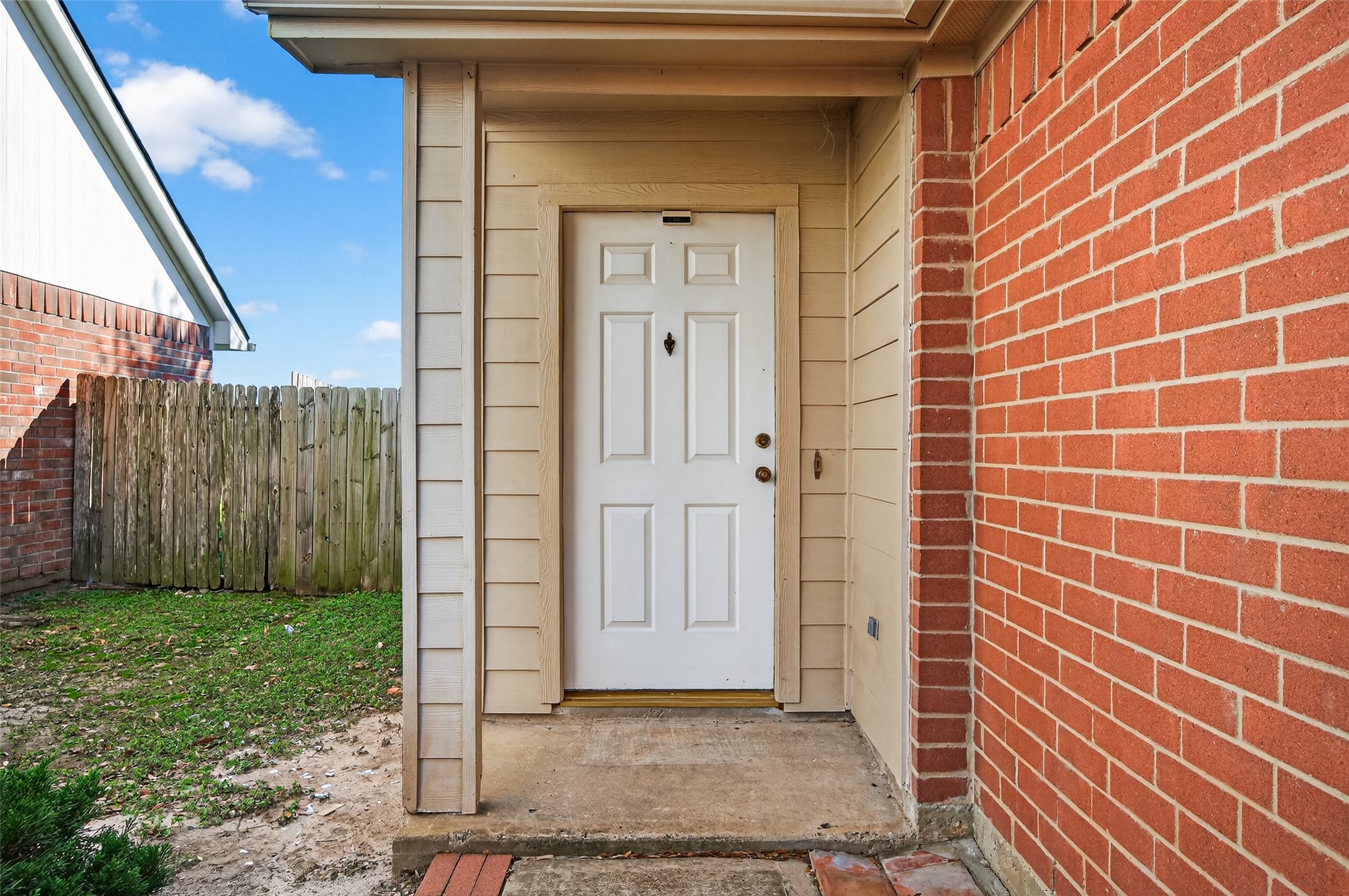 20347 Hunterclif Lane Katy, TX 77449 - Photo 4 of 39 Intimate look at the covered front porch entry featuring a six-panel security door and low-maintenance brick siding.