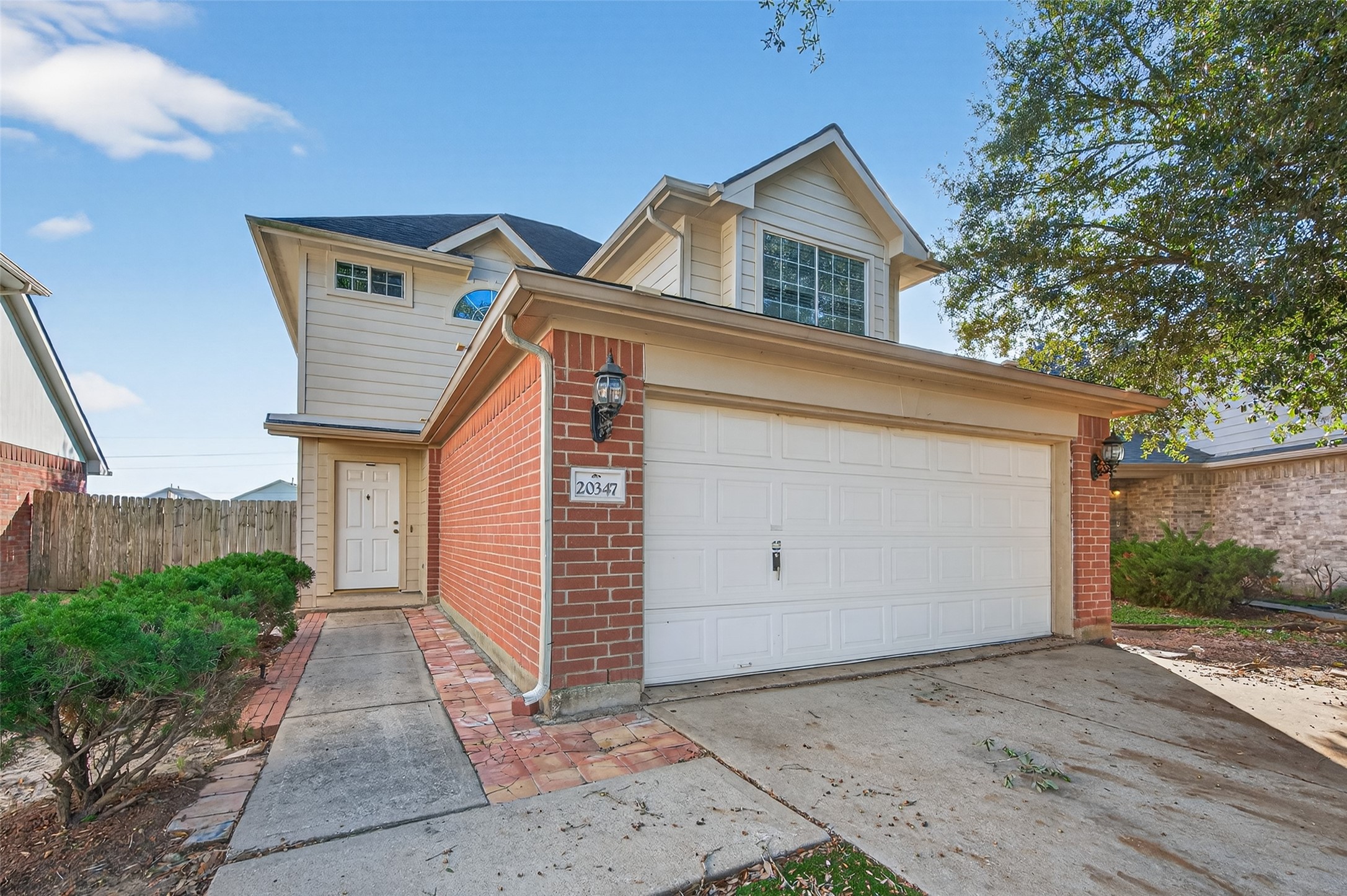 20347 Hunterclif Lane Katy, TX 77449 - Photo 5 of 39 Clear view of the attached two-car garage and the paved walkway leading to the covered front entrance.