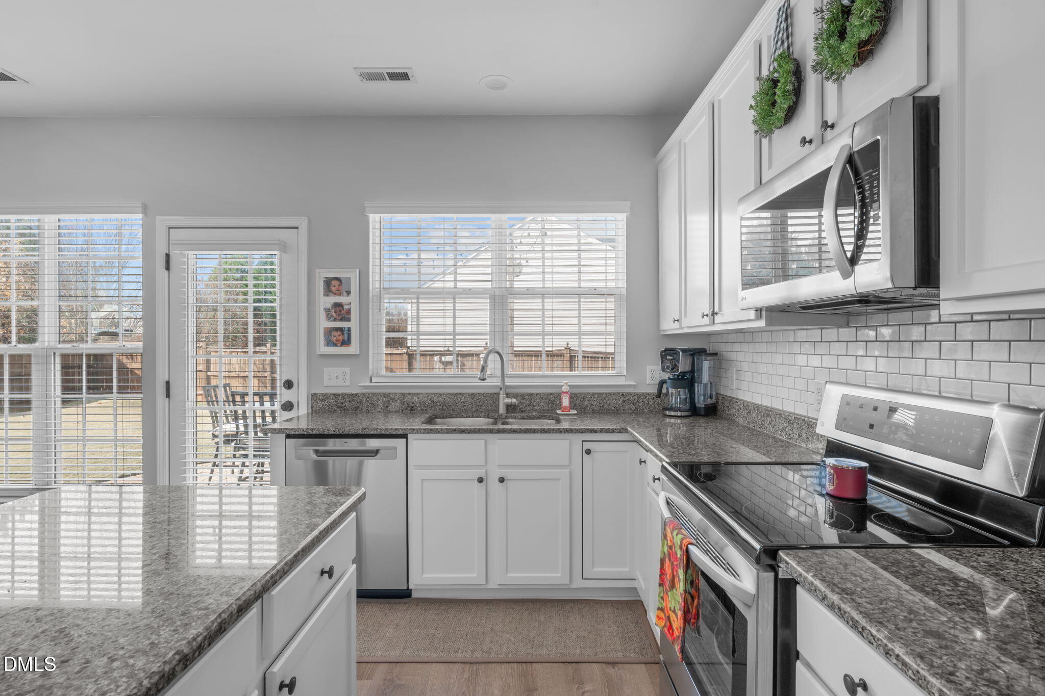 7461 Lagrange Drive Raleigh, NC 27613 - Photo 20 of 54 a kitchen with a sink stove and cabinets