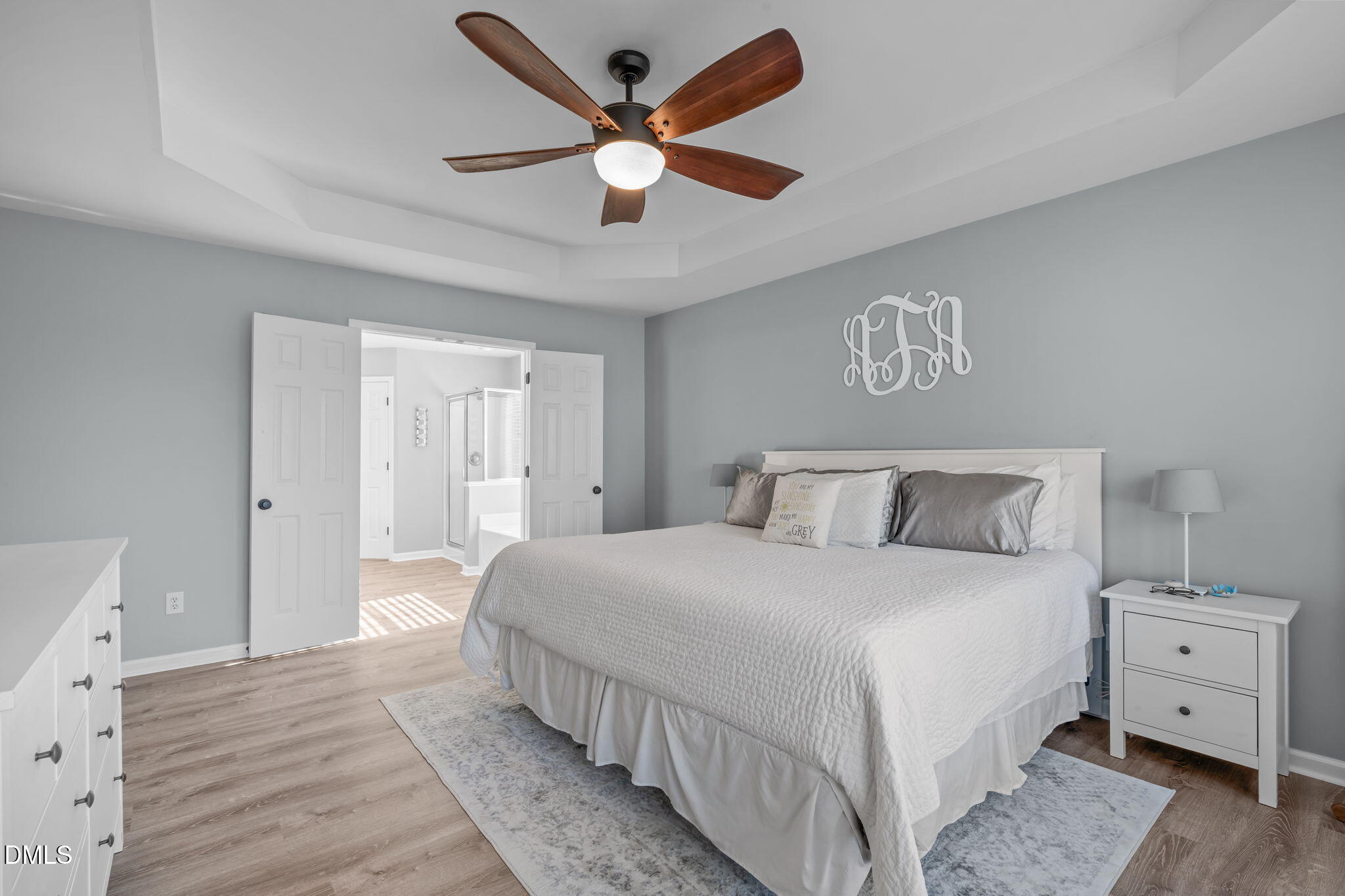 7461 Lagrange Drive Raleigh, NC 27613 - Photo 29 of 54 a bedroom with a large bed and a ceiling fan
