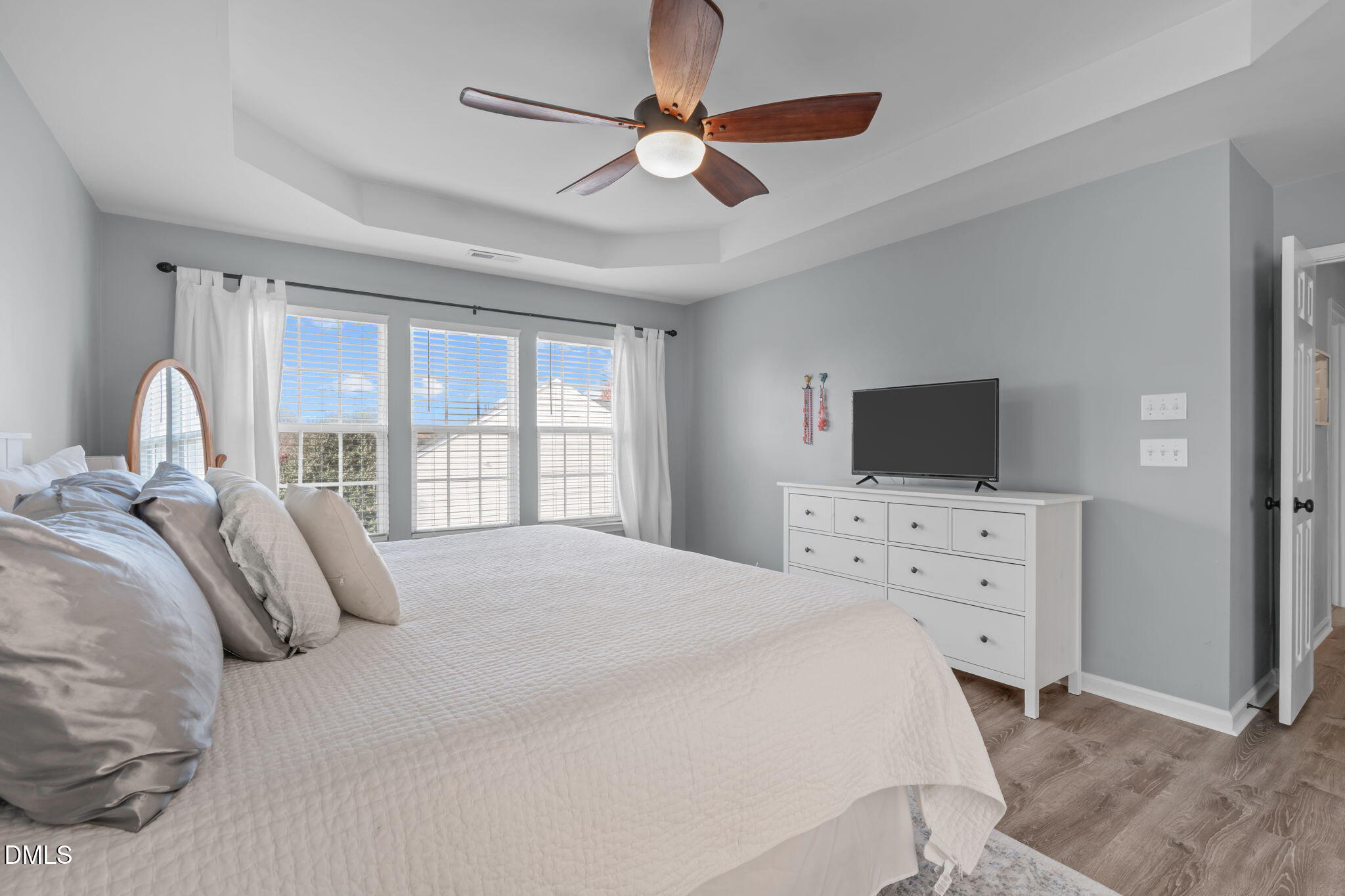 7461 Lagrange Drive Raleigh, NC 27613 - Photo 30 of 54 a bedroom with a bed and a flat screen tv