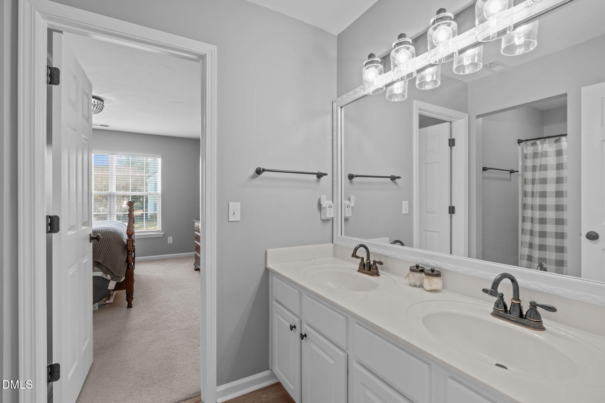 7461 Lagrange Drive Raleigh, NC 27613 - Photo 40 of 54 a en suite spacious bathroom with a double vanity sink a mirror and shower