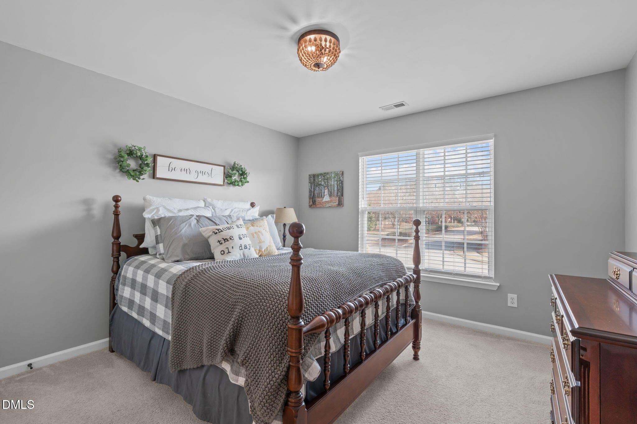 7461 Lagrange Drive Raleigh, NC 27613 - Photo 42 of 54 a bedroom with a bed window and a table in it