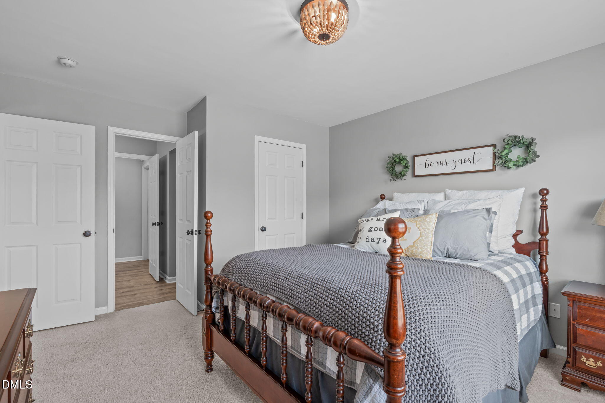 7461 Lagrange Drive Raleigh, NC 27613 - Photo 43 of 54 a bedroom with a bed and a chandelier
