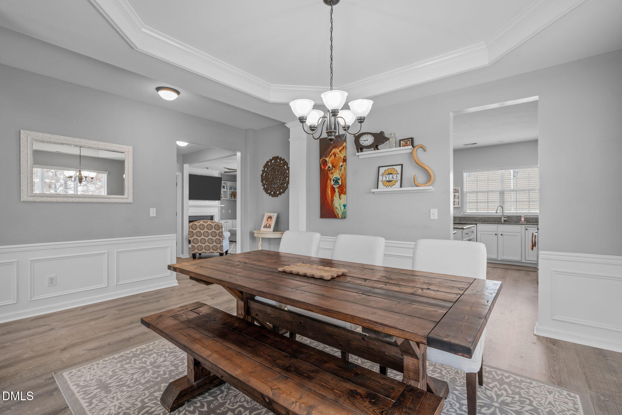 7461 Lagrange Drive Raleigh, NC 27613 - Photo 9 of 54 a view of a dining room with furniture a chandelier and wooden floor