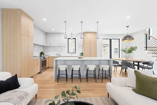 a living room with lots of furniture and kitchen view