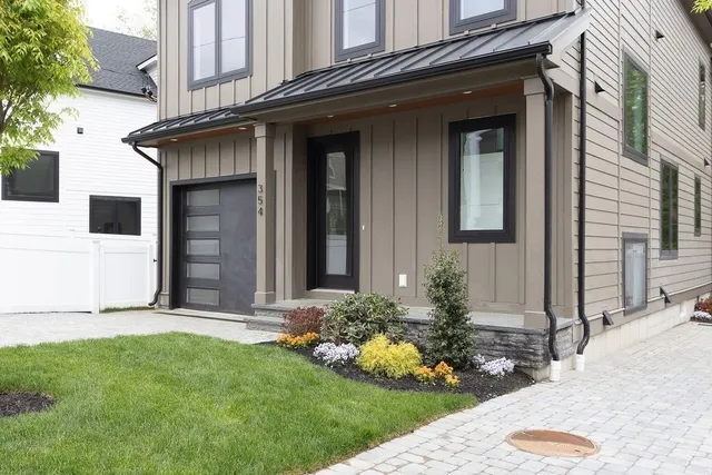 a view of a house with small yard plants and a fountain