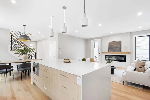 a view of living room kitchen with stainless steel appliances granite countertop living room and white cabinets