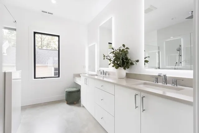 a bathroom with a double vanity sink and a mirror