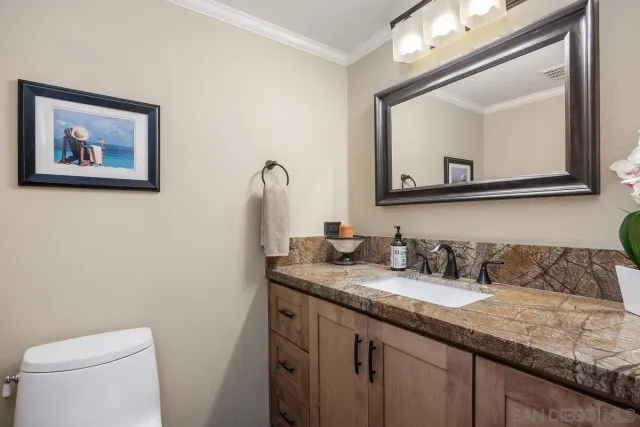 a bedroom with a bed and a tv on dresser