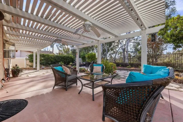 a view of a patio with couple of chairs and a table
