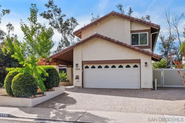 a view of a white house with a outdoor space