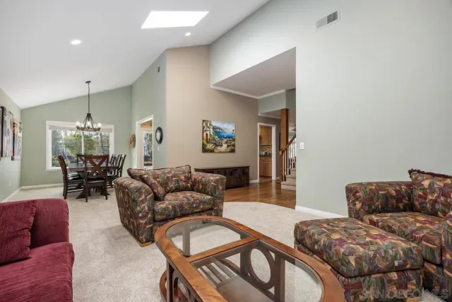 a view of a dining room with furniture and chandelier