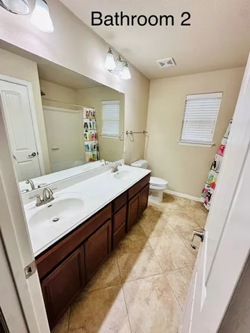 an empty room with a ceiling fan and window