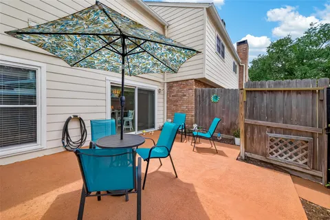 a patio with table and chairs