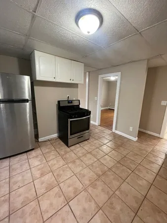a kitchen with a sink and a refrigerator