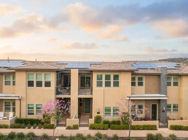 a front view of a residential apartment building with a yard