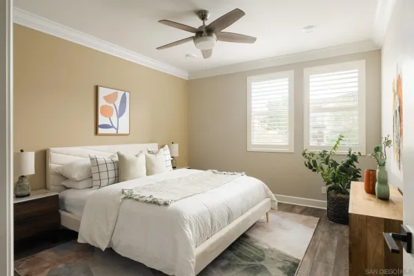 a bedroom with a large bed and a chandelier