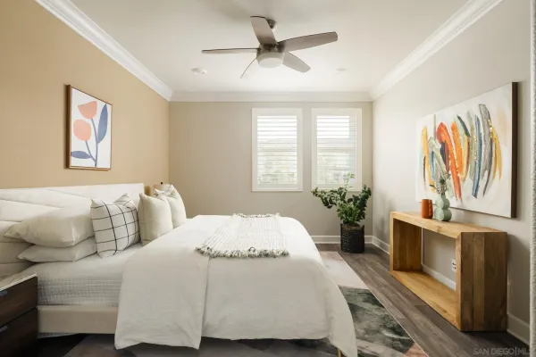 a bedroom with a large bed and a chandelier