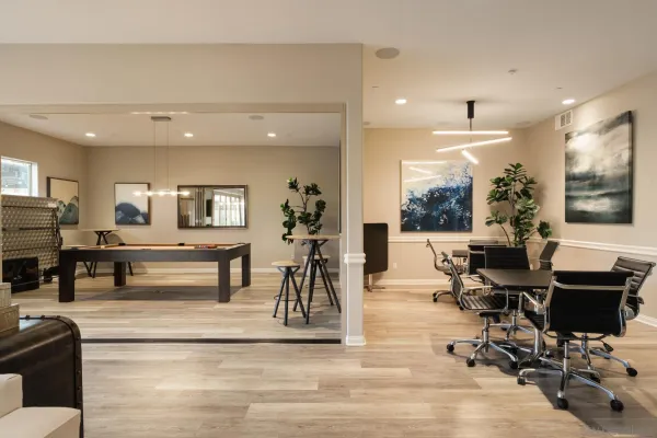 a living room with furniture a dining table and a large window