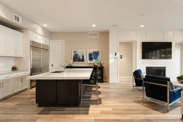 a kitchen with stainless steel appliances kitchen island granite countertop a sink and a stove