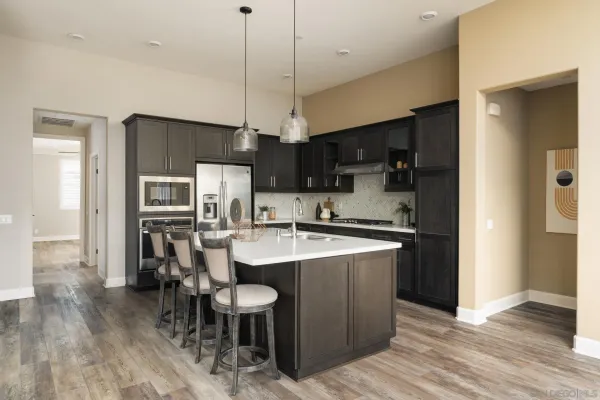 a kitchen with stainless steel appliances a sink stove and refrigerator