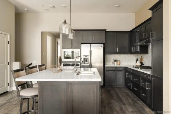 a kitchen with sink cabinets and appliances