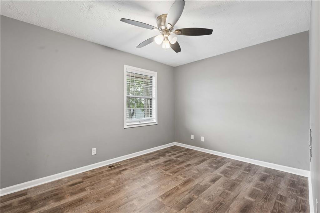 1235 Riverside Drive, Unit C8 Gainesville, GA 30501 - Photo 11 of 24 wooden floor in an empty room with a window