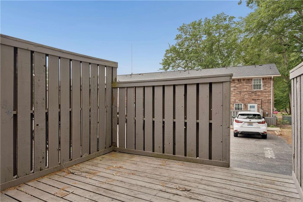 1235 Riverside Drive, Unit C8 Gainesville, GA 30501 - Photo 18 of 24 a view of a balcony with wooden floor and fence