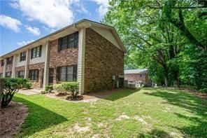 1235 Riverside Drive, Unit C8 Gainesville, GA 30501 - Photo 2 of 24 a front view of a house with a yard and garage