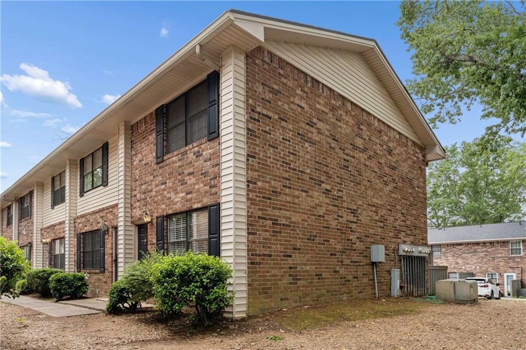 1235 Riverside Drive, Unit C8 Gainesville, GA 30501 - Photo 23 of 24 a front view of a house with a yard