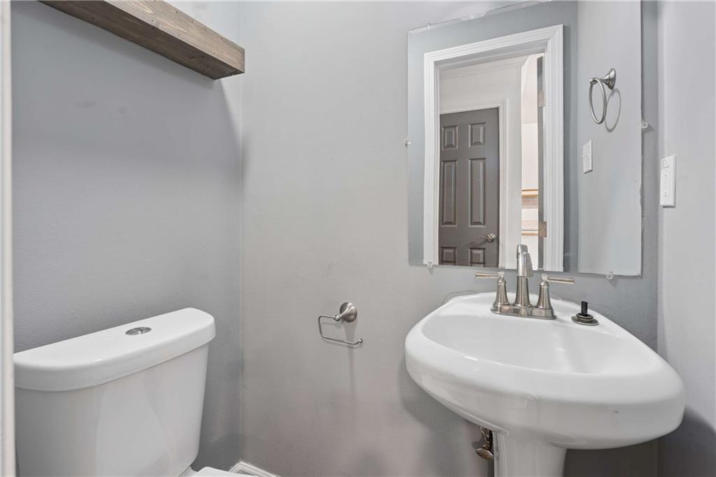 1235 Riverside Drive, Unit C8 Gainesville, GA 30501 - Photo 10 of 24 a bathroom with a sink a toilet and a mirror