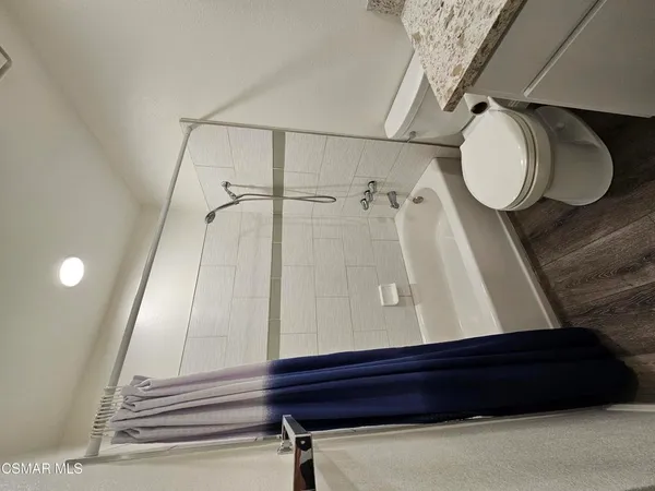 a bathroom with a mirror and a shower